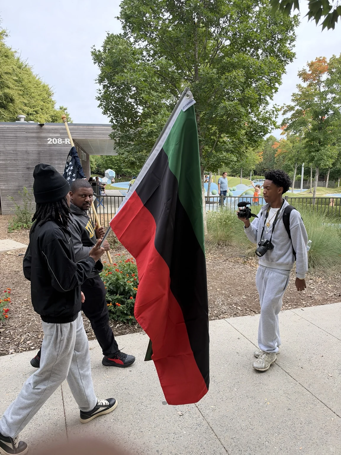 A flag walk being documented by a community photographer